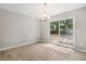 Dining room with sliding glass doors to backyard and chandelier, wood-look floors at 9513 Bahia Rd, Ocala, FL 34472