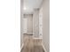 Hallway with wood-look floors leads to a closet and other rooms at 9513 Bahia Rd, Ocala, FL 34472