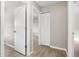Hallway with wood-look floors and white doors at 9513 Bahia Rd, Ocala, FL 34472