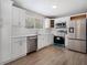 Modern kitchen with stainless steel appliances, white cabinets, and ample counter space at 9513 Bahia Rd, Ocala, FL 34472