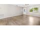Bright living room features light gray walls, wood-look floors, and a ceiling fan at 9513 Bahia Rd, Ocala, FL 34472
