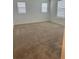 Spacious carpeted room featuring three windows, neutral paint and new carpeting at 11713 Tidal Alley Trl, Orlando, FL 32832