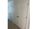 Hallway featuring carpet and white panel doors at 11713 Tidal Alley Trl, Orlando, FL 32832