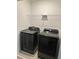 Modern laundry room with black Samsung washer and dryer at 11713 Tidal Alley Trl, Orlando, FL 32832