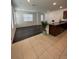 Open-concept space with luxury vinyl plank flooring and tile near kitchen at 11713 Tidal Alley Trl, Orlando, FL 32832