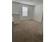 A cozy loft space with neutral carpet, one window and painted in a neutral color at 11713 Tidal Alley Trl, Orlando, FL 32832