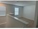 A cozy loft space with neutral carpet, two windows and painted in a neutral color at 11713 Tidal Alley Trl, Orlando, FL 32832