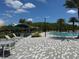 Community pool area with lounge chairs and palm trees at 11713 Tidal Alley Trl, Orlando, FL 32832
