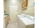 Functional laundry room with modern appliances, storage shelving, and ample counter space at 14313 Dulcimer Ct, Orlando, FL 32837