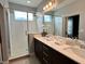 This bathroom features double sinks with modern fixtures and a glass-enclosed shower with natural light at 236 Villa Domani Cir, Davenport, FL 33896