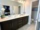 Bathroom boasts dual sinks with modern fixtures, generous counter space, and a well-lit mirror at 236 Villa Domani Cir, Davenport, FL 33896