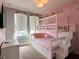 Charming bedroom with a unique bunk bed, floral accents, and natural light from the windows at 236 Villa Domani Cir, Davenport, FL 33896