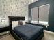 Stylish bedroom with unique wallpaper, modern lighting, and a comfortable-looking bed at 236 Villa Domani Cir, Davenport, FL 33896