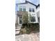 Modern two-story home with stone accents, stylish landscaping, and a paved pathway to the entrance at 236 Villa Domani Cir, Davenport, FL 33896