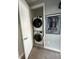 Efficient laundry closet with stacked washer and dryer for space-saving convenience at 236 Villa Domani Cir, Davenport, FL 33896