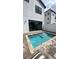 Backyard pool area with patio pavers, a privacy fence, and a modern home exterior at 236 Villa Domani Cir, Davenport, FL 33896