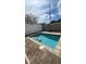 Backyard pool with paver surround, a privacy fence, and a relaxing outdoor space at 236 Villa Domani Cir, Davenport, FL 33896