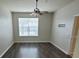 Bedroom with wood-look flooring, fan, and large window at 3351 Whitestone Cir # 101, Kissimmee, FL 34741