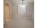 Open dining area features modern light fixture, neutral paint, and tile flooring at 3351 Whitestone Cir # 101, Kissimmee, FL 34741