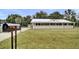 Inviting single-story home featuring a large, charming front porch and well-maintained lawn with a metal roof at 616 Se 31St Ter, Ocala, FL 34471