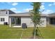 Home exterior featuring a grassy backyard and sliding glass door at 6389 Clover St, Lake Hamilton, FL 33851