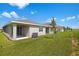 Home exterior showcasing a spacious green backyard with sliding glass doors at 6389 Clover St, Lake Hamilton, FL 33851