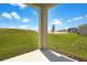A view of the green backyard with grass and a view of other houses at 6389 Clover St, Lake Hamilton, FL 33851