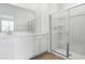 Bright bathroom with double vanity, quartz countertop and glass enclosed shower at 6389 Clover St, Lake Hamilton, FL 33851