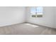 Sunlit bedroom with soft carpeting and a large window at 6389 Clover St, Lake Hamilton, FL 33851