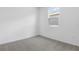 Vacant bedroom featuring plush carpet and a window offering natural light at 6389 Clover St, Lake Hamilton, FL 33851