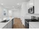 Stylish kitchen features white cabinets, stainless steel appliances, and an open layout at 6389 Clover St, Lake Hamilton, FL 33851