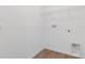 Laundry room with tile floor, washer/dryer hookups, and overhead shelving at 6389 Clover St, Lake Hamilton, FL 33851