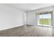Bright living room with large sliding glass doors and neutral-toned flooring at 6389 Clover St, Lake Hamilton, FL 33851