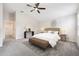Bright bedroom with a ceiling fan, decorative rug, bench, and neutral decor at 1848 Ancestry Trl, Kissimmee, FL 34746