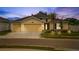 Charming yellow home with a three-car garage, palm tree, and well-manicured lawn at 1848 Ancestry Trl, Kissimmee, FL 34746