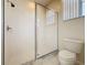 Bathroom featuring glass enclosed shower, toilet, and window at 205 Minniehaha Cir, Haines City, FL 33844