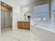 Bright bathroom with a tub, a shower and wood cabinets at 205 Minniehaha Cir, Haines City, FL 33844