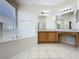 Bathroom with garden tub, double sinks, and tile floors at 205 Minniehaha Cir, Haines City, FL 33844
