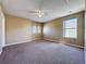 Spacious bedroom with neutral walls, carpeted floors and a ceiling fan at 205 Minniehaha Cir, Haines City, FL 33844