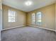 Spacious carpeted bedroom featuring natural light from two arched top windows at 205 Minniehaha Cir, Haines City, FL 33844