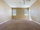 Spacious carpeted bedroom with windows and door at 205 Minniehaha Cir, Haines City, FL 33844