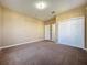 Spacious bedroom with neutral walls, carpet, and white closet doors at 205 Minniehaha Cir, Haines City, FL 33844