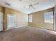 Carpeted bedroom with three windows and door to the yard at 205 Minniehaha Cir, Haines City, FL 33844