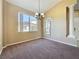 Bright dining room with hanging light fixture, carpet, and tall windows at 205 Minniehaha Cir, Haines City, FL 33844