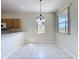 Bright dining area featuring tiled flooring, chandelier and backyard view at 205 Minniehaha Cir, Haines City, FL 33844