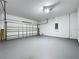 Spacious two-car garage with concrete floor, white walls, and sectional garage door at 205 Minniehaha Cir, Haines City, FL 33844