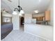 Open concept kitchen flows into living area, showcasing a breakfast bar and easy transition to other living spaces at 205 Minniehaha Cir, Haines City, FL 33844