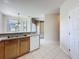 Bright kitchen features tile flooring, white appliances, and a functional layout for easy meal preparation at 205 Minniehaha Cir, Haines City, FL 33844