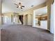 Open living room featuring carpet, staircase, large front door and view to kitchen area at 205 Minniehaha Cir, Haines City, FL 33844