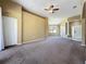 Spacious living room features carpet, ceiling fan, archways, and natural light from the window at 205 Minniehaha Cir, Haines City, FL 33844